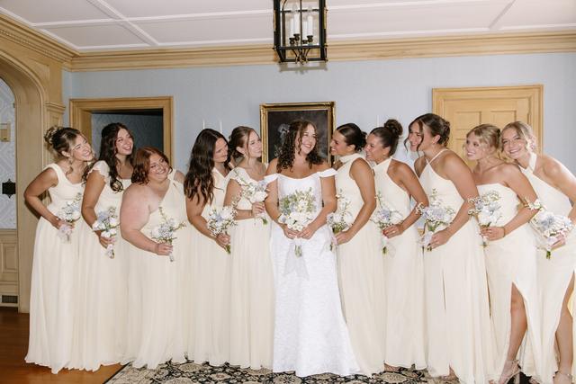 Bride with her bridesmaids in the blue parlor of the house