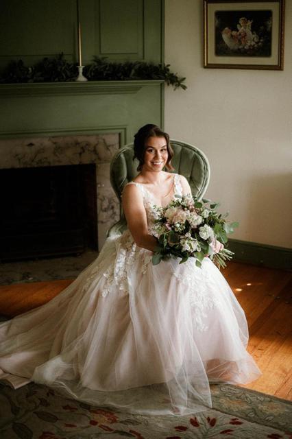Bride seated by the fireplace in the house