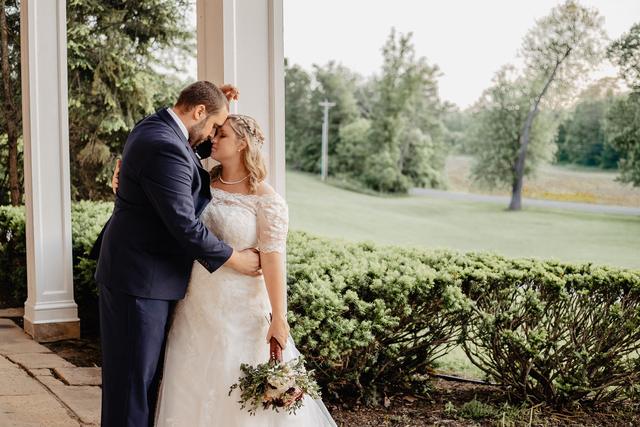 Couple kissing on the porch of the house