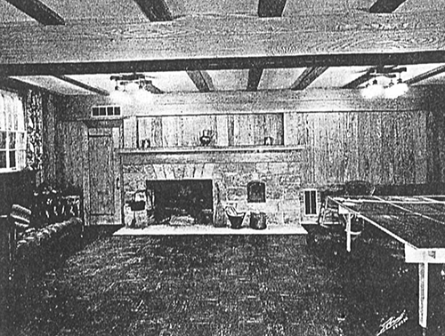 Historic photo of the pecky cypress game room with a woodburning fireplace