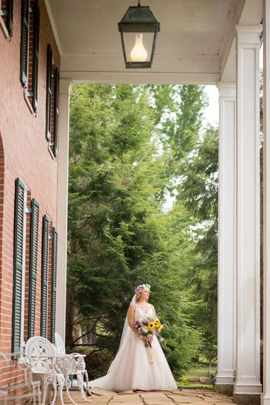 bride standing outside the house