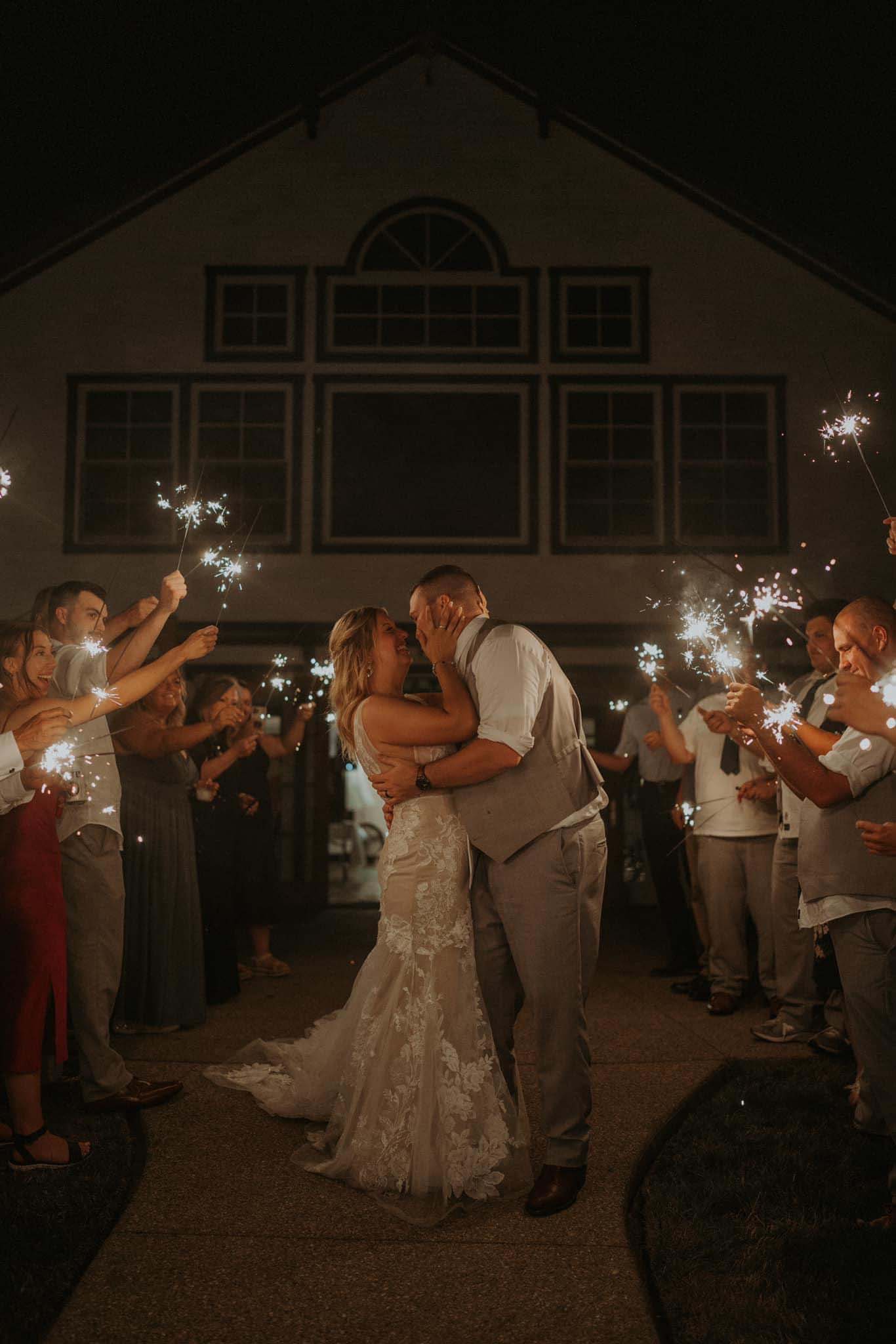 bride and groom, wedding guests holding sparklers