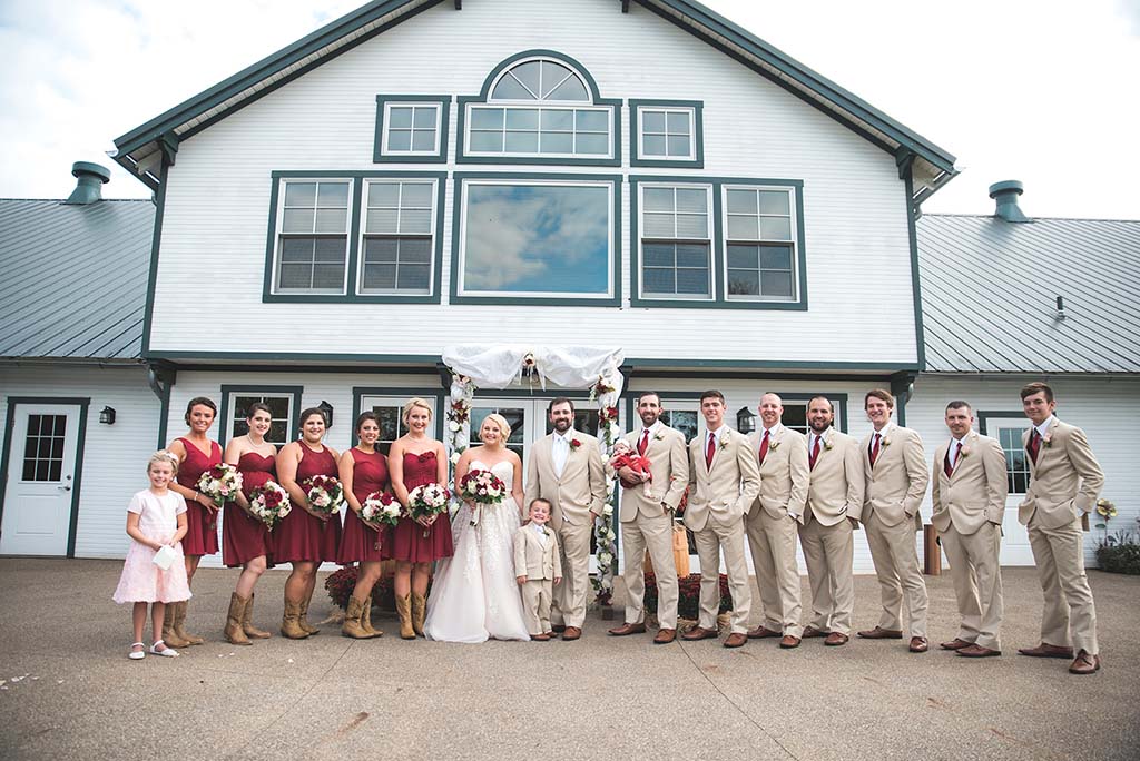 bridal party outside in front of barn