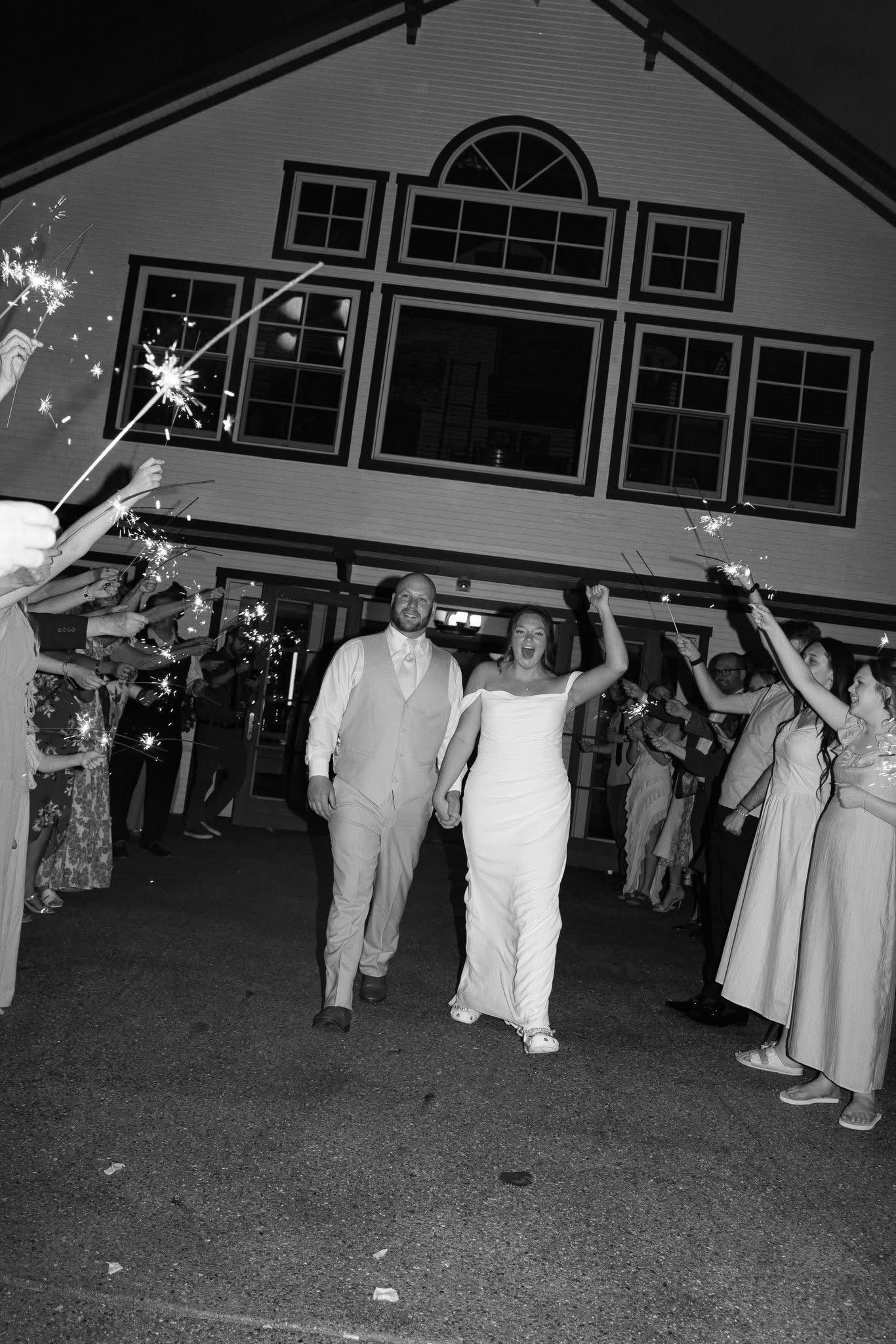 Black and white sparkler send-off as the couple leaves the barn