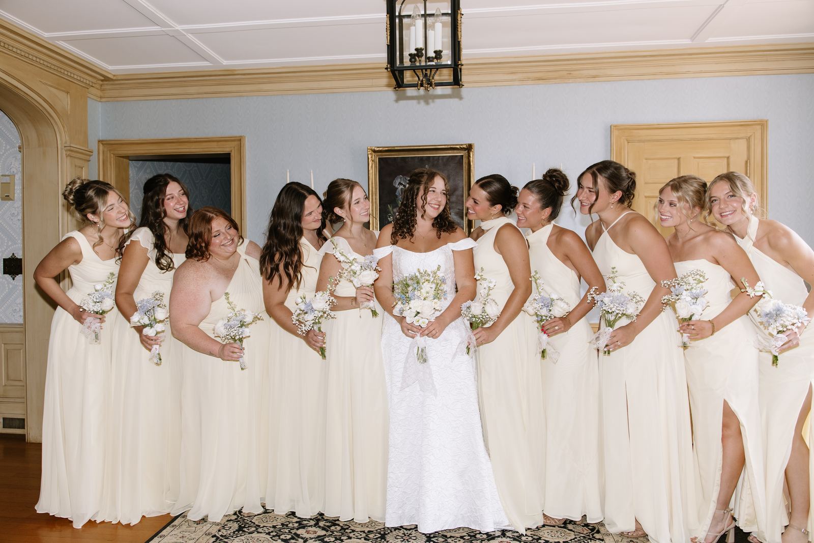 Bride with her bridesmaids in the blue parlor of the house