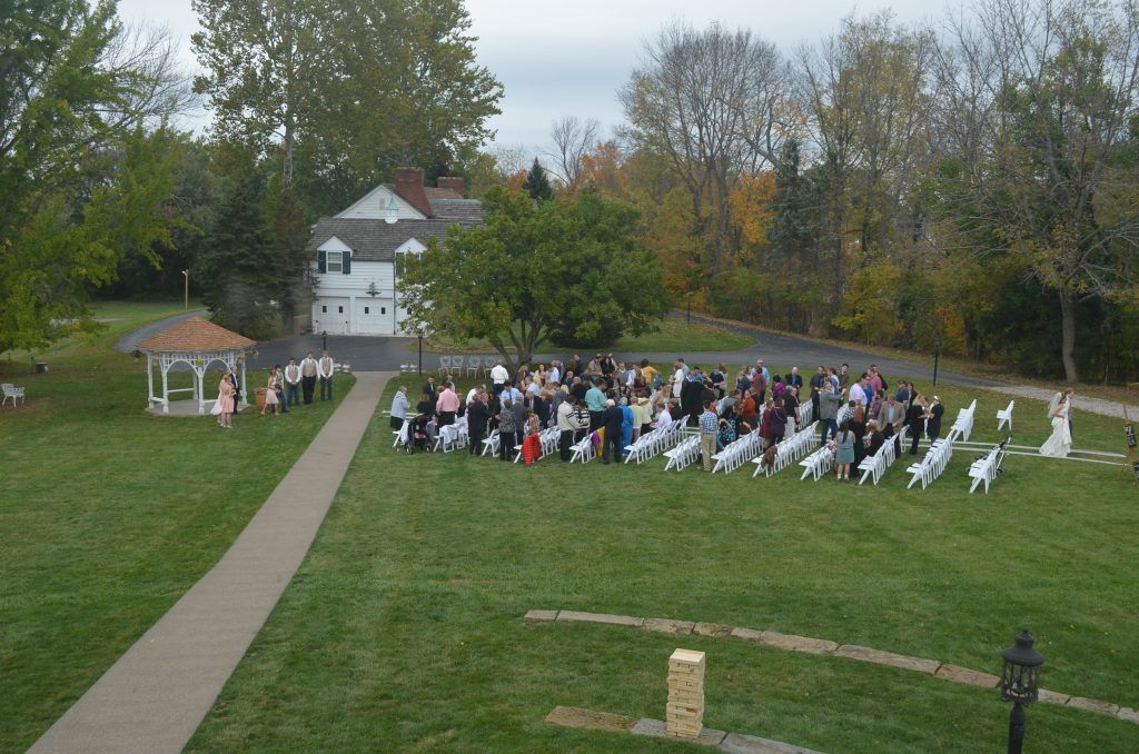 Aerial view of a lawn ceremony beside the gazebo and the house