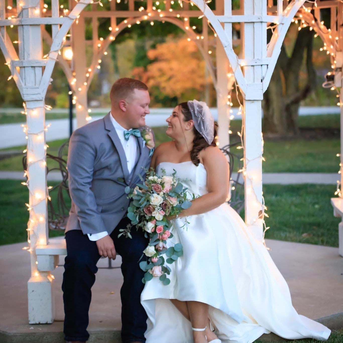 Bride and groom in the lighted white gazebo
