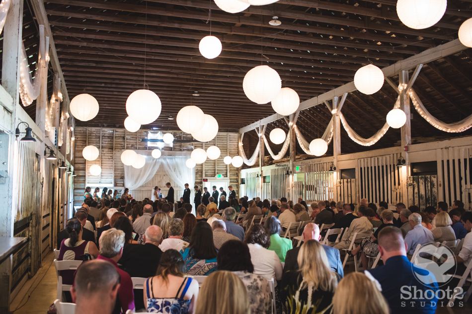 Indoor barn ceremony with guests seated