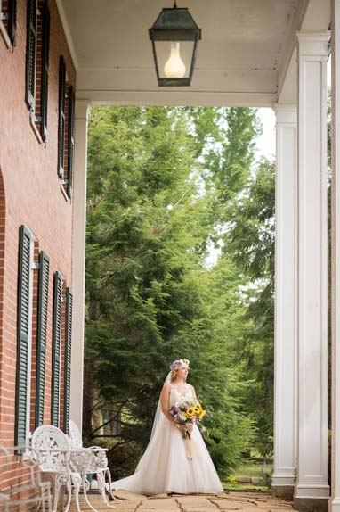Bride on the porch of the house