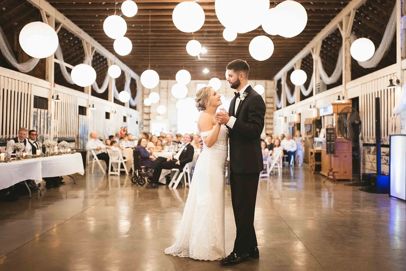 Couple sharing their first dance under paper lanterns